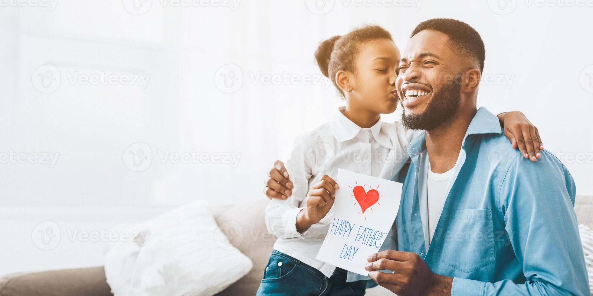 Happy daughter kissing dad and giving greeting card photo