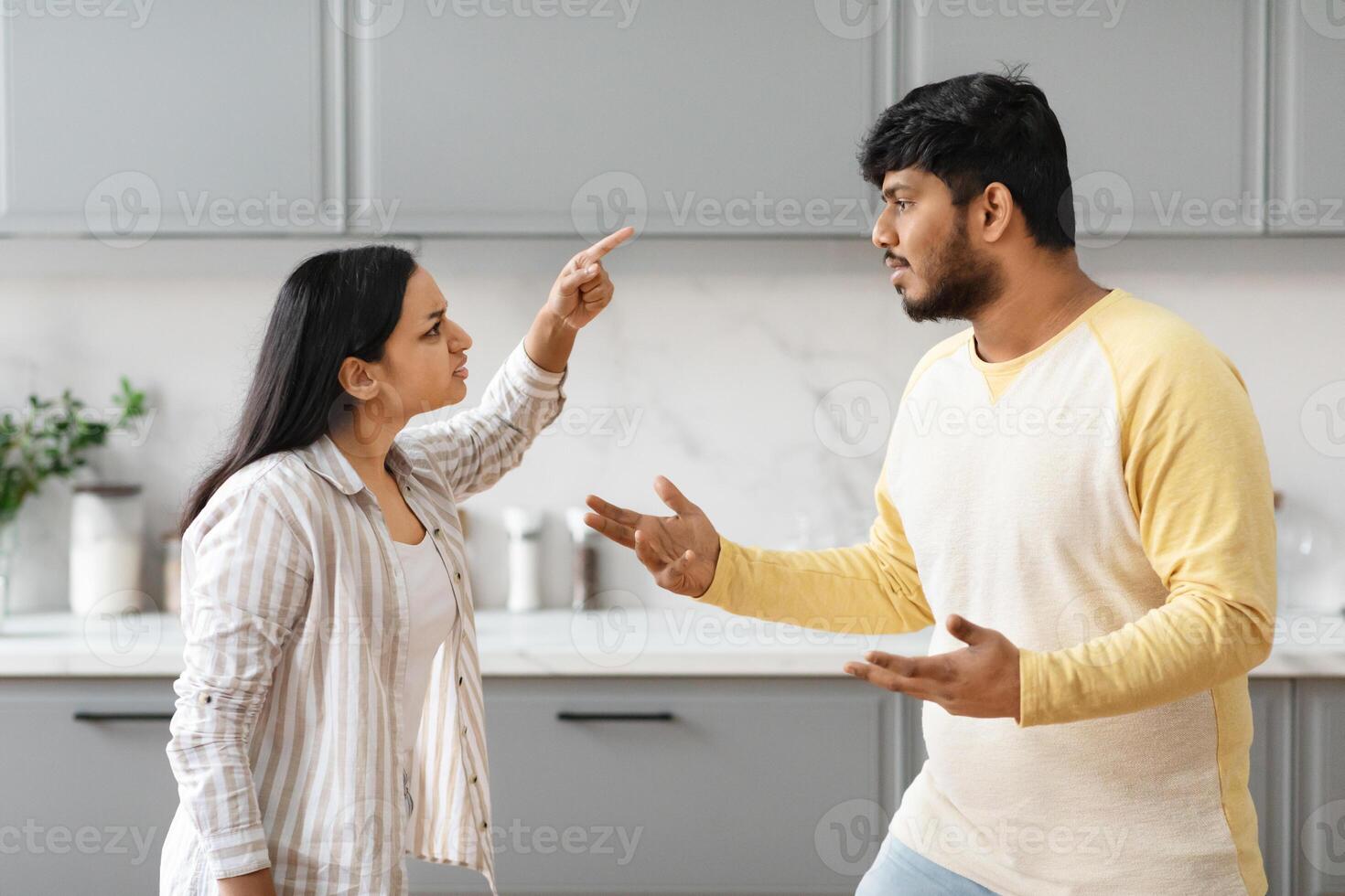 Furious millennial indian couple have fight, kitchen interior photo