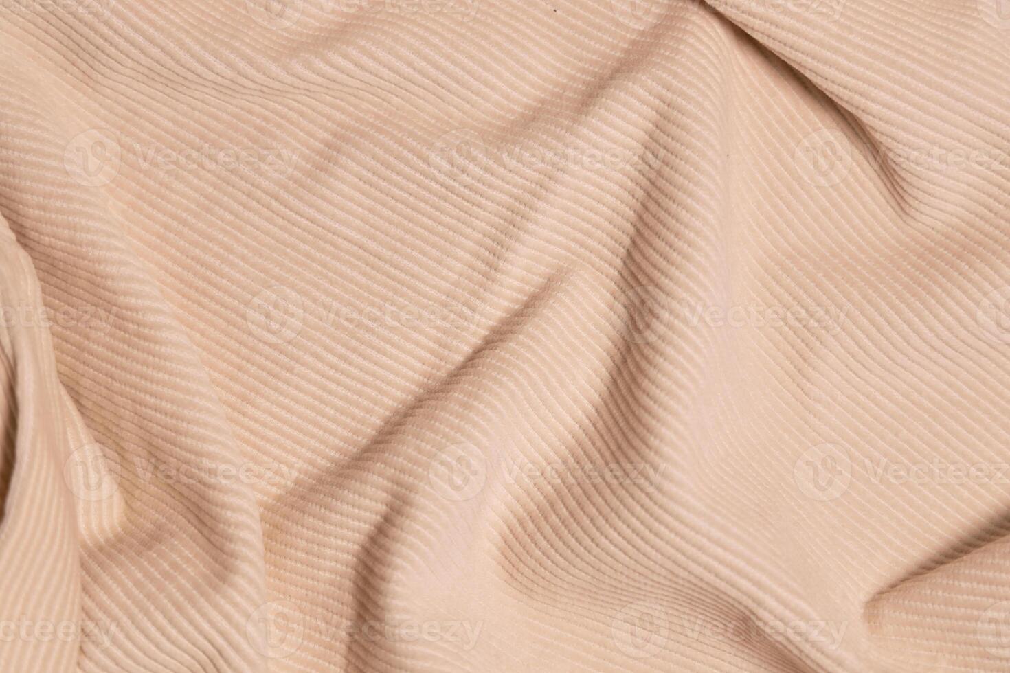 Velvety fabric texture pattern. Texture of velvet textile nude color. photo