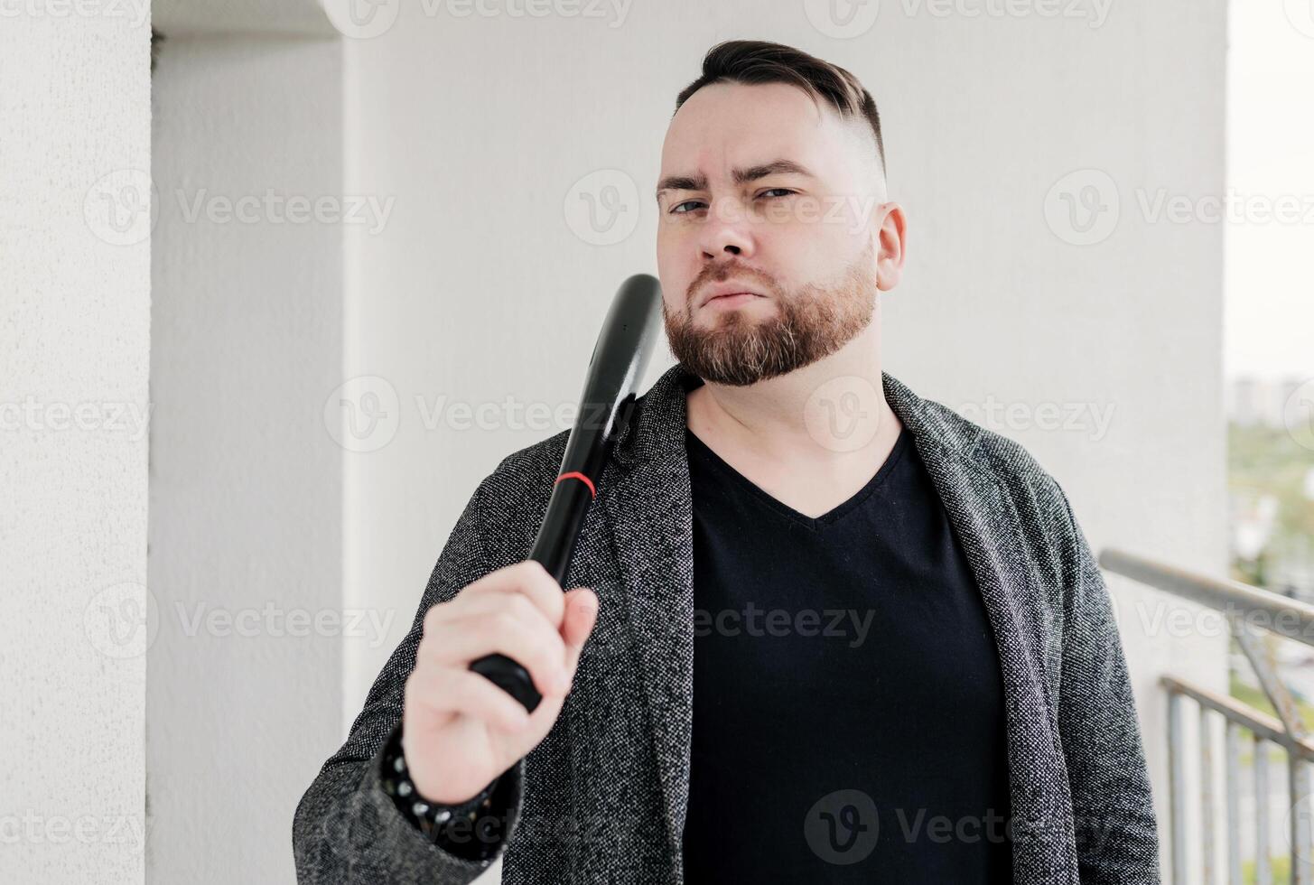 bearded man with black bat photo