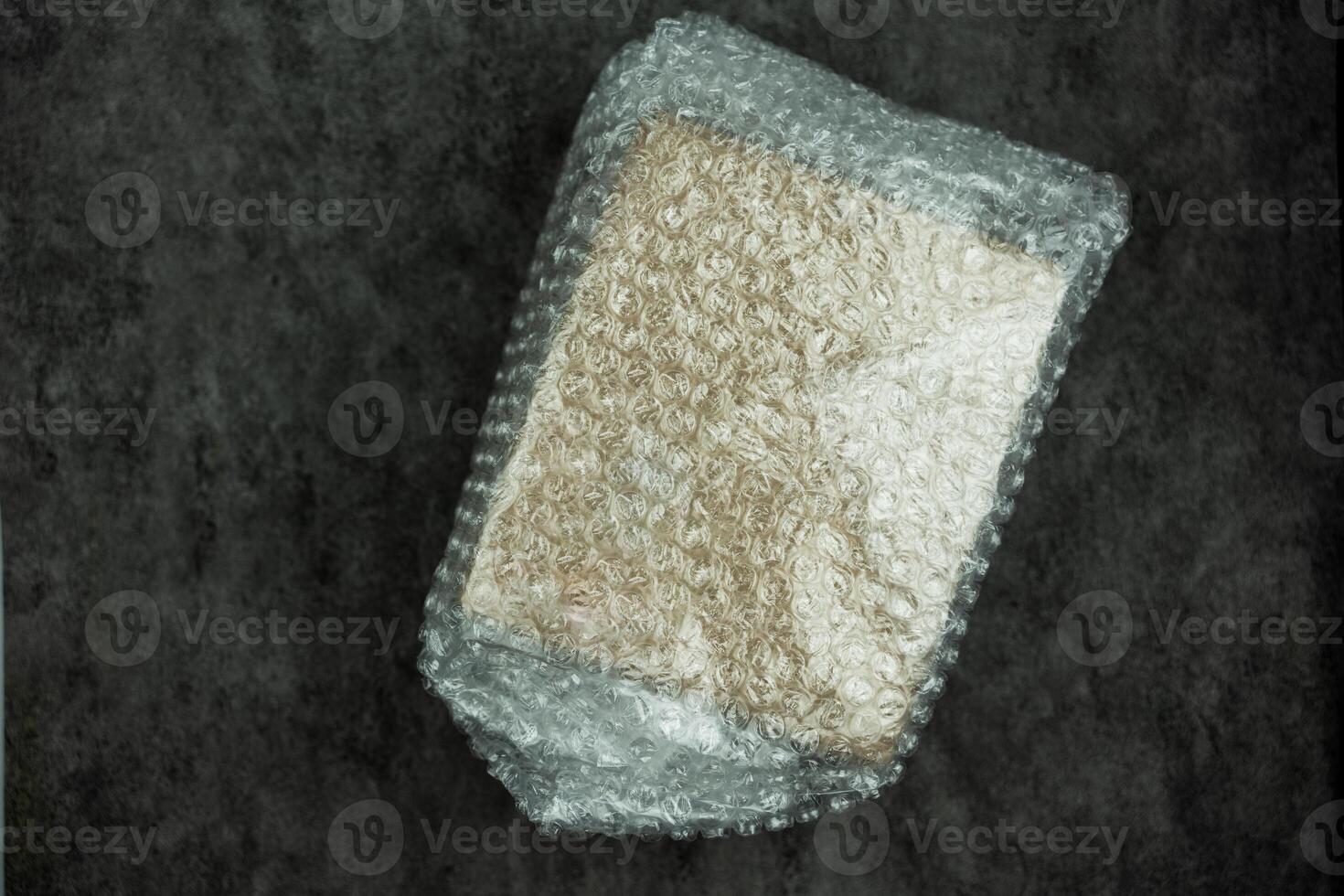 Cardboard box covered with bubble wrap packaging protection photo