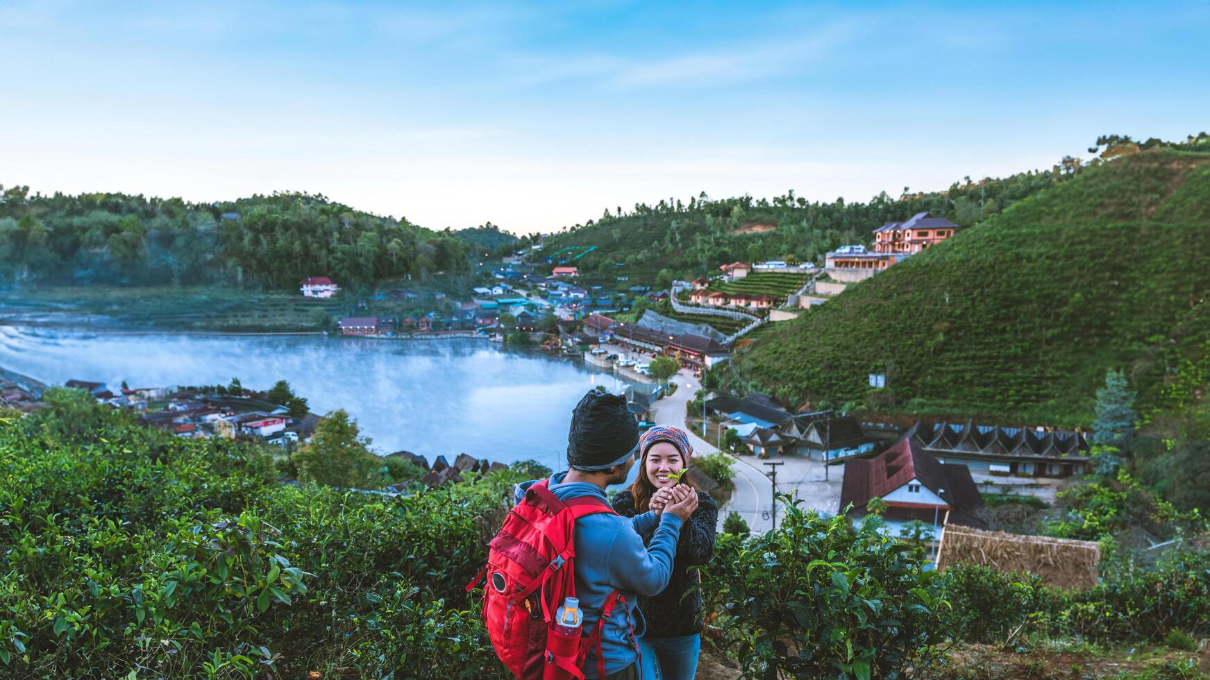 Couple Asian traveling together on mountain in Ban Rak Thai village countryside. Travel, camping in the winter, Outdoor relaxation, Romantic couples. photo