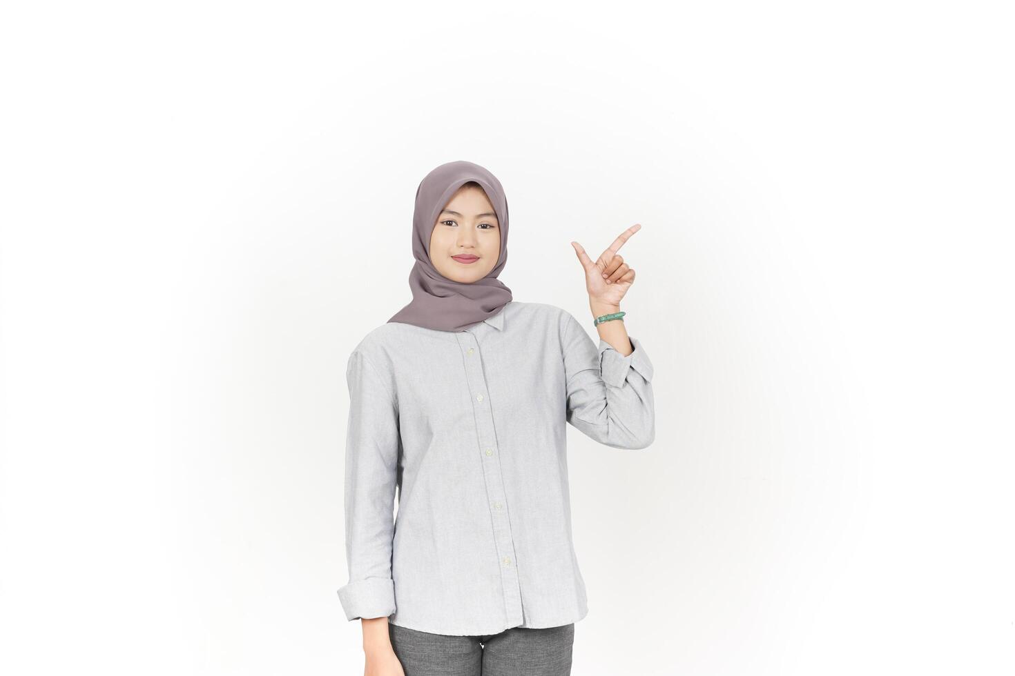 Young Asian woman wearing hijab Pointing side copy space isolated on white background photo