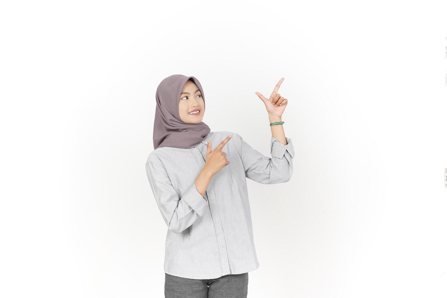 Young Asian woman wearing hijab Pointing side copy space isolated on white background photo