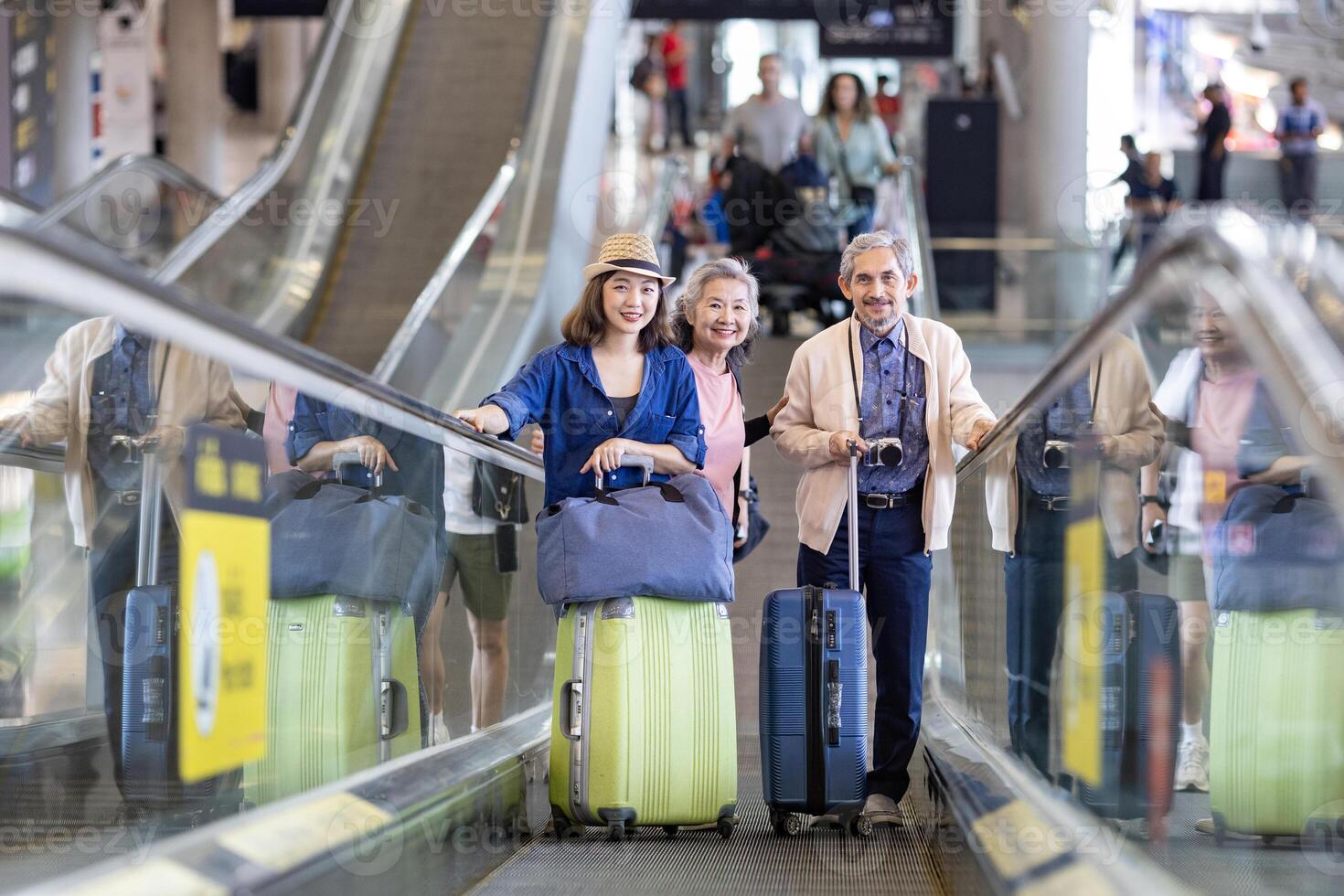 Group of Asian family tourist passenger with senior parent using escalator at the airport terminal for airline travel and holiday vacation photo