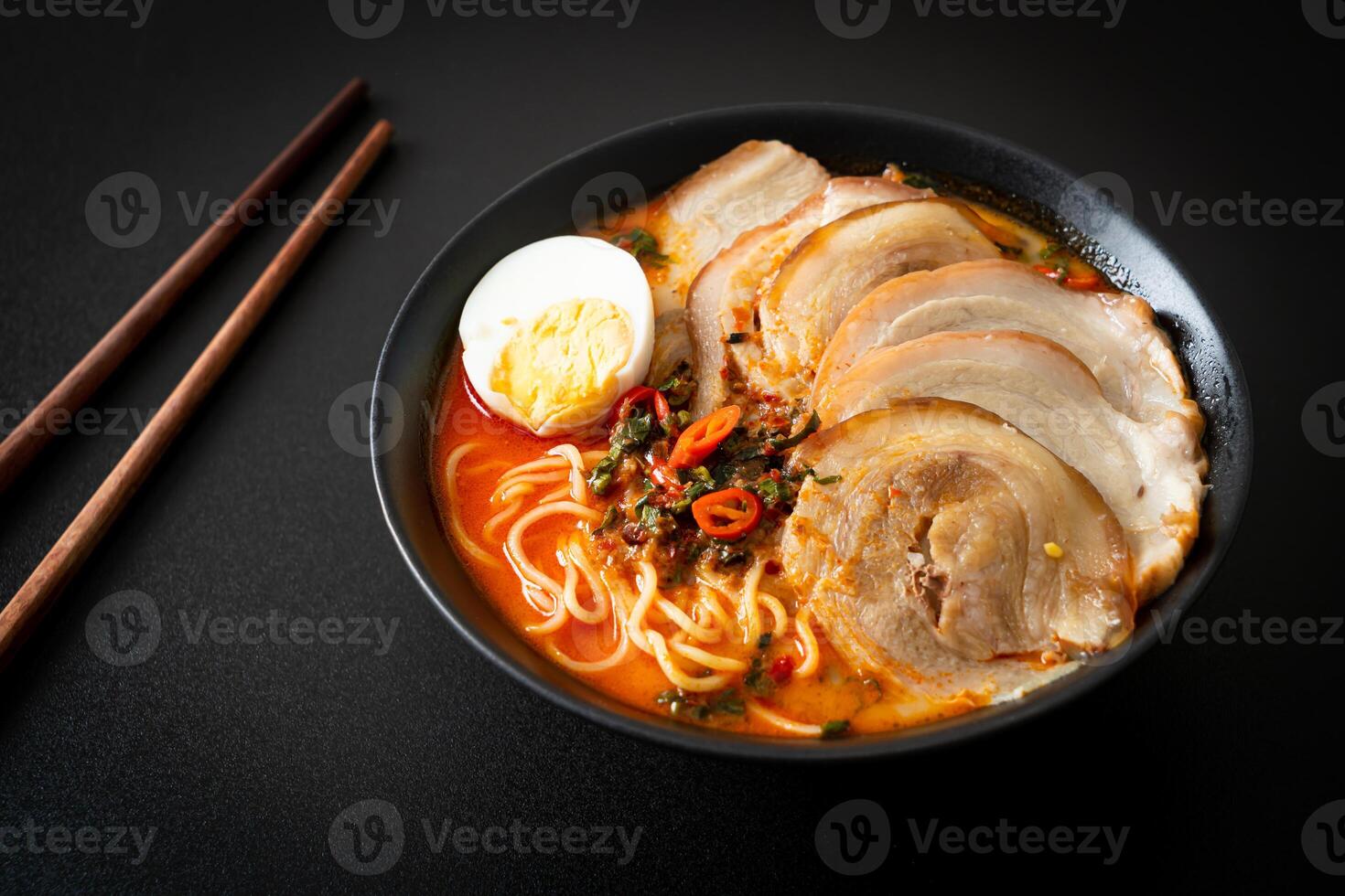 Ramen Noodles Spicy Tomyum Soup with Roast Pork photo