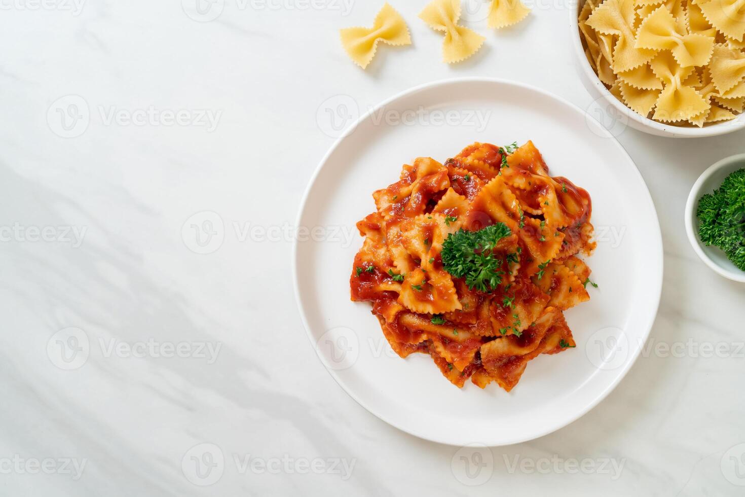 farfalle pasta in tomato sauce with parsley photo