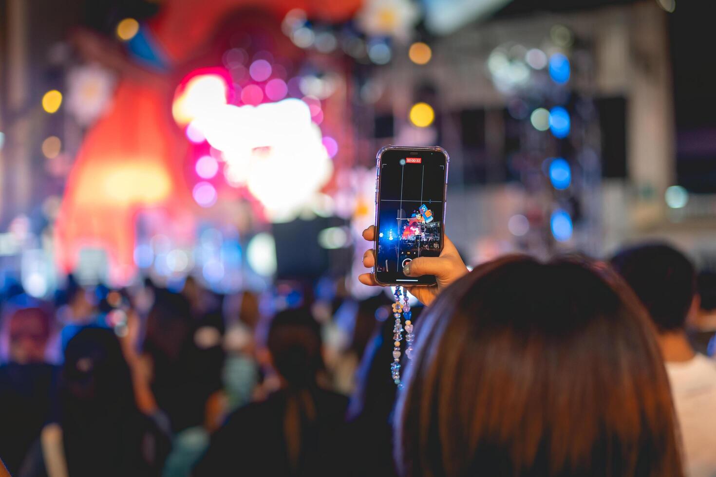 People holding smart phone and recording and photographing in concert , silhouette of hands with mobile , event background concept photo