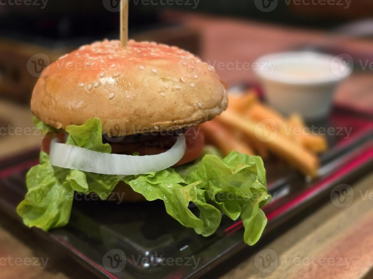 Beef burger and French fries with fresh vegetable, Close up and blurred background. Food Concept. photo