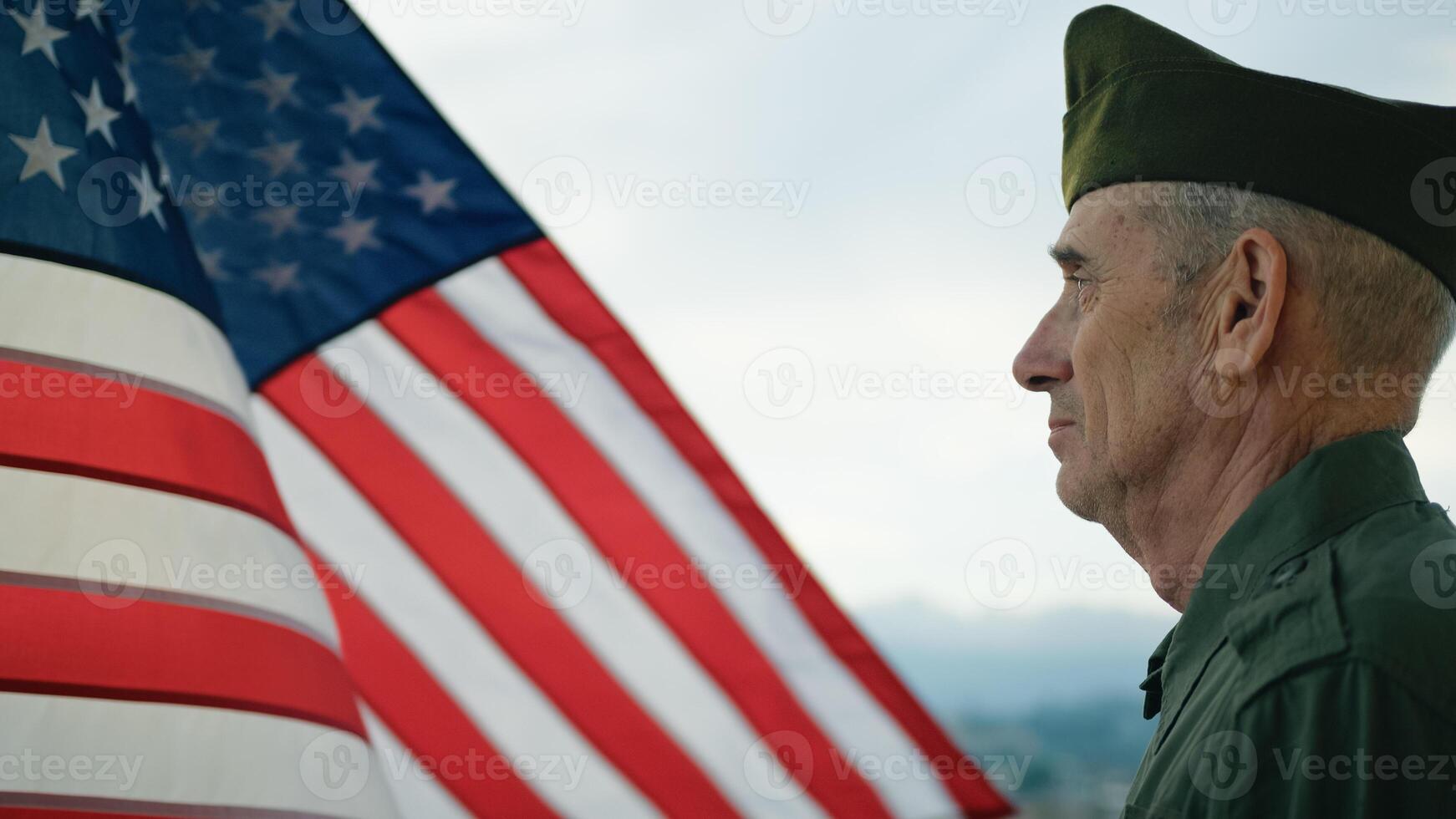 Elderly Man Stand Against American Flag For Veterans Day Holiday photo
