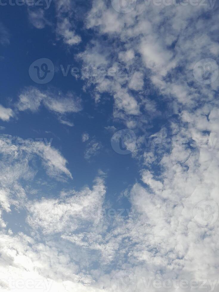 Beautiful white clouds on deep blue sky background. Large bright soft fluffy clouds are cover the entire blue sky. Skyscape on Lombok Island, Indonesia photo