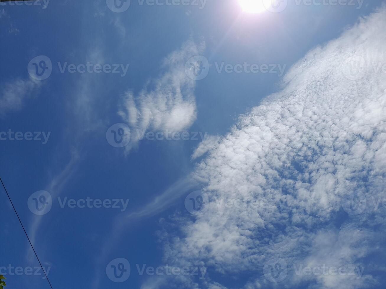 Beautiful white clouds on deep blue sky background. Large bright soft fluffy clouds are cover the entire blue sky. Skyscape on Lombok Island, Indonesia photo