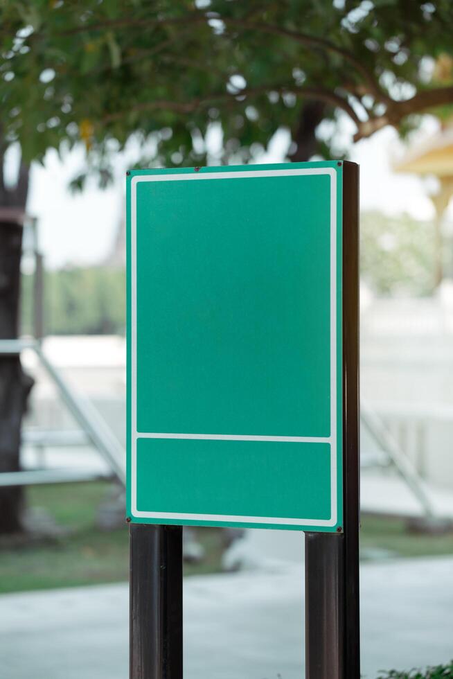 Empty green metal sign in public area. photo