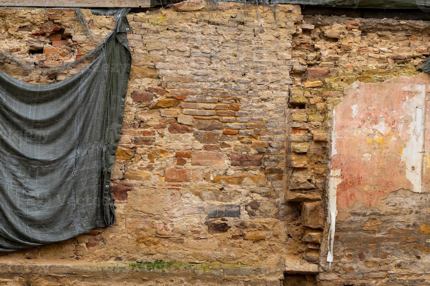 wall with a brick wall and a curtain hanging on it photo