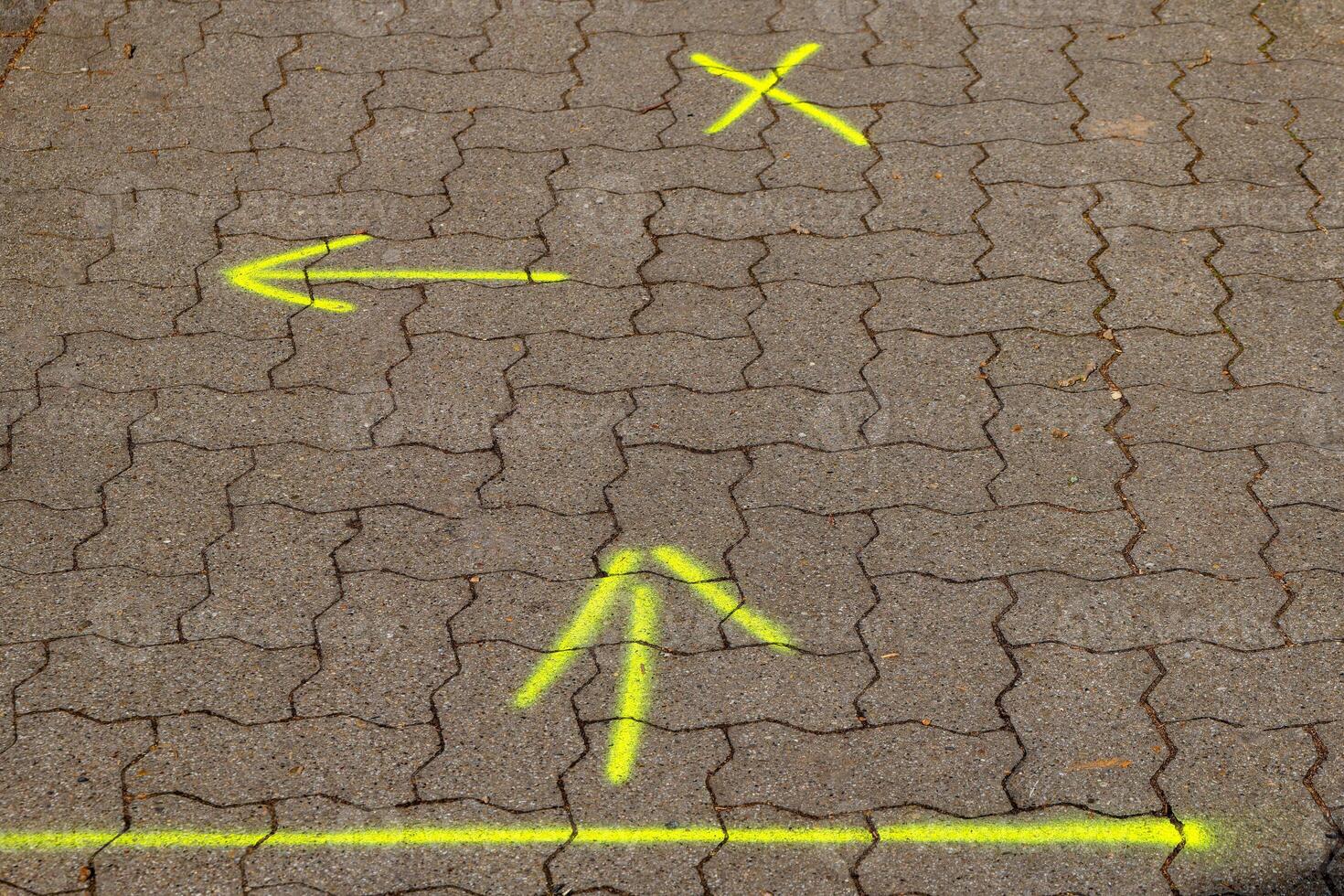 yellow arrows on a footpath photo