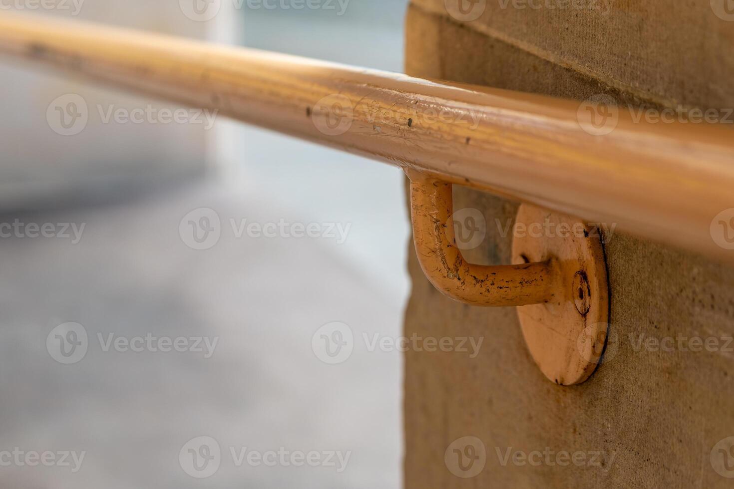 metal railing is attached to a concrete wall photo