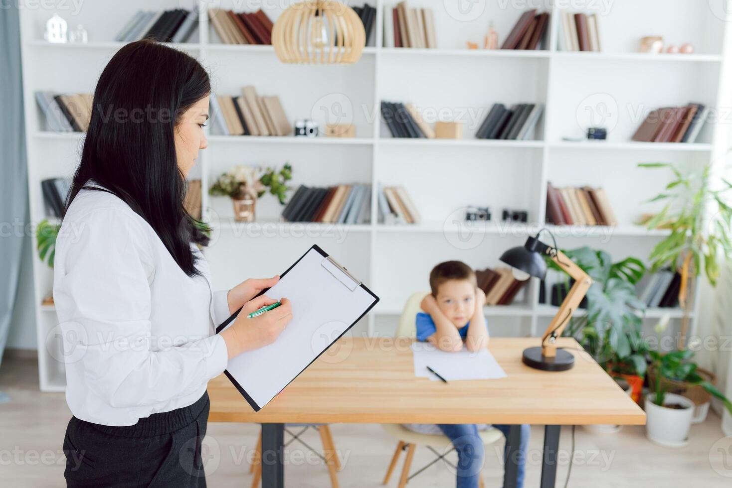 Picture of child psychologist working with young boy in office photo
