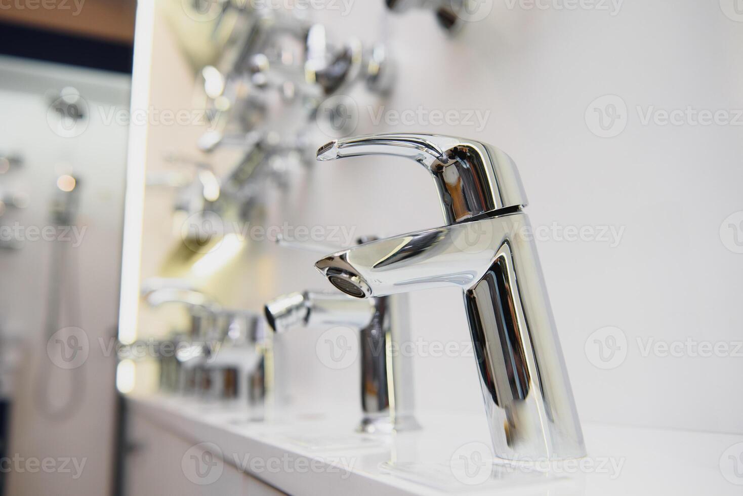 Rows of new faucets in plumbing shop, closeup photo