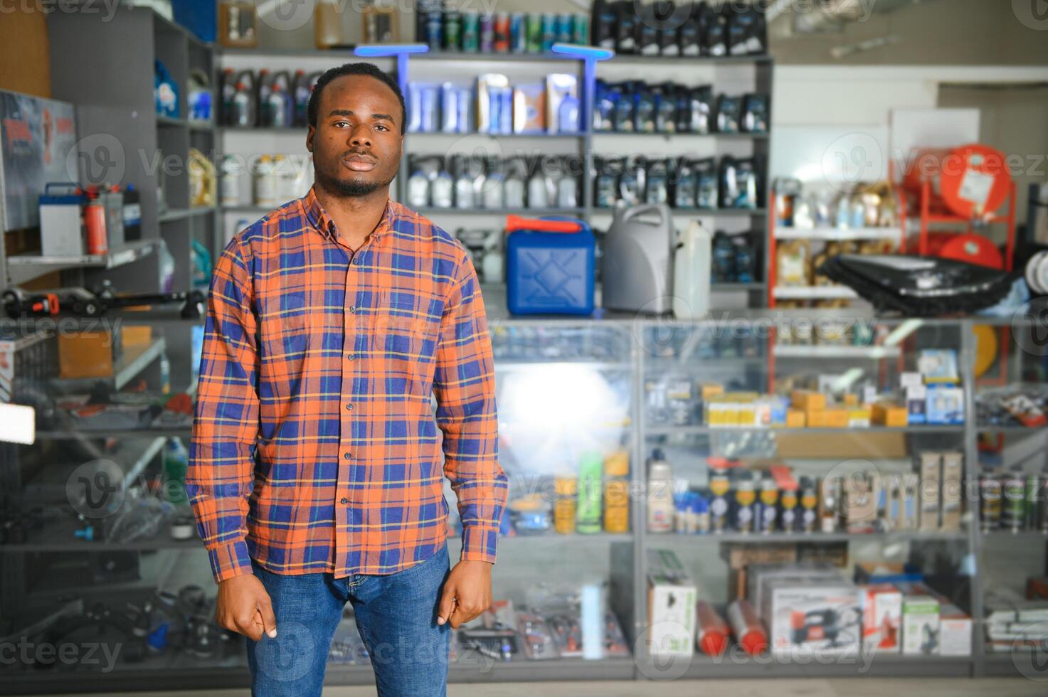 Portrait of a handsome african salesman in an auto parts store. The concept of car repair photo