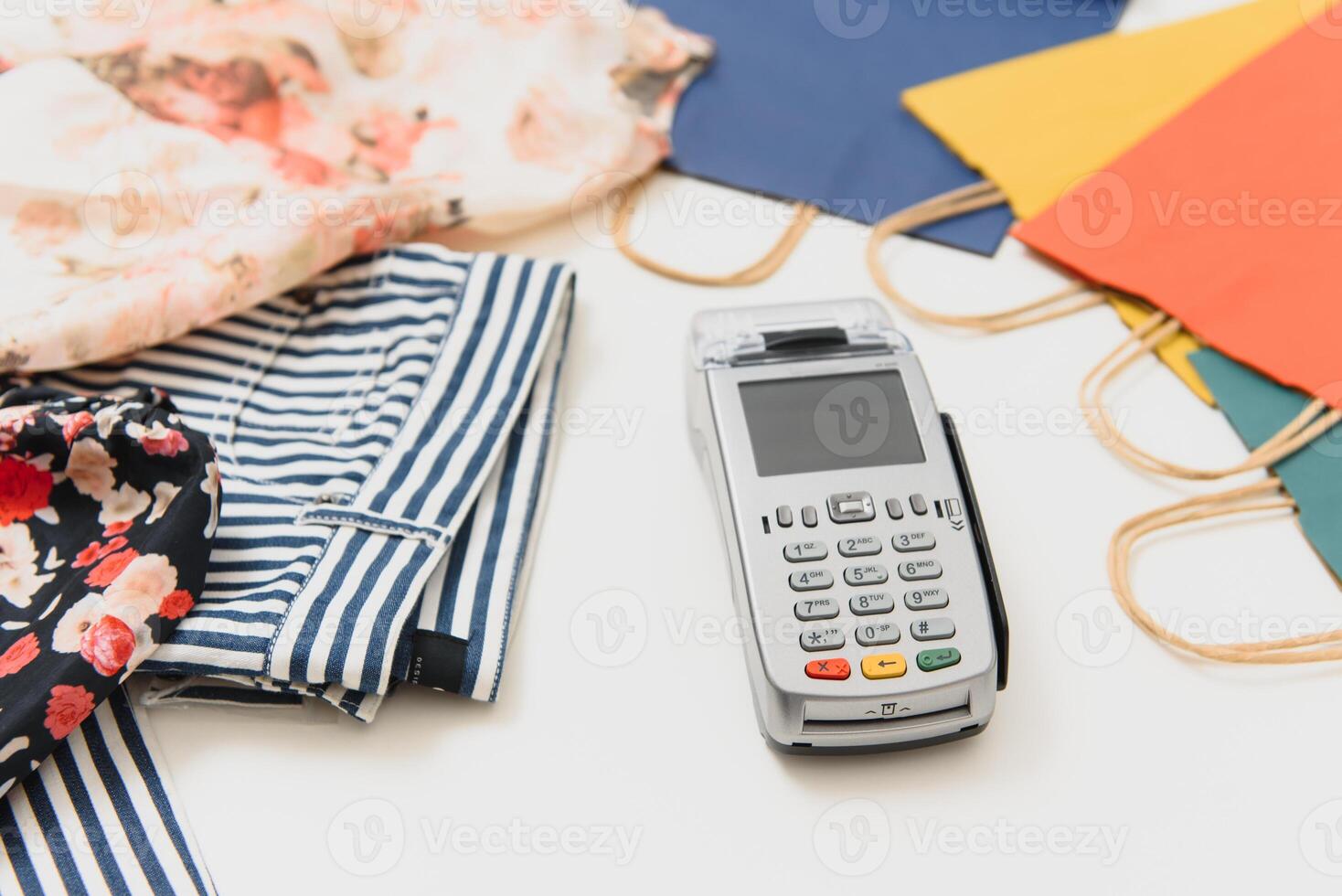 Close up of hand using credit card swiping machine to pay. credit card payment through a shopping terminal. Credit card payment for new clothing collection photo