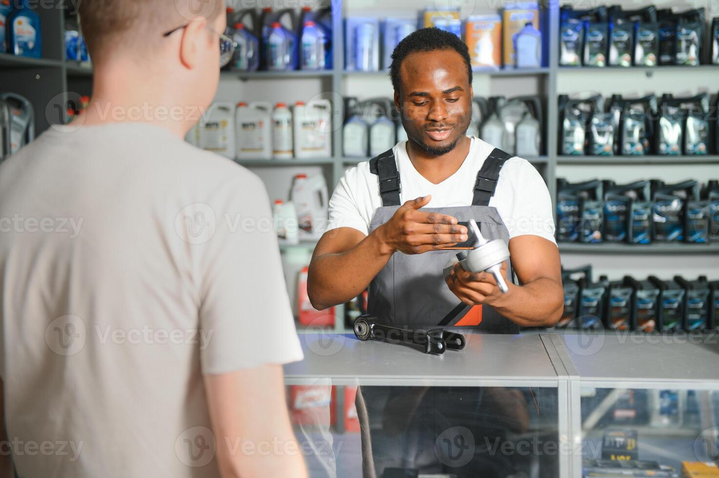 A customer is talking to a salesperson at an auto parts store photo