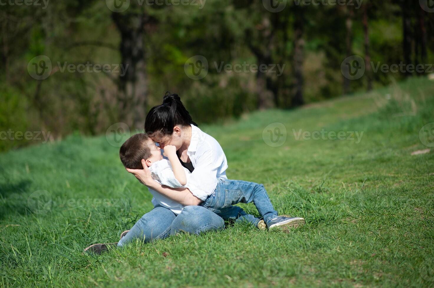 Stilish mother and handsome son having fun on the nature. Happy family concept. Beauty nature scene with family outdoor lifestyle. Happy family resting together. Happiness in family life. Mothers day. photo