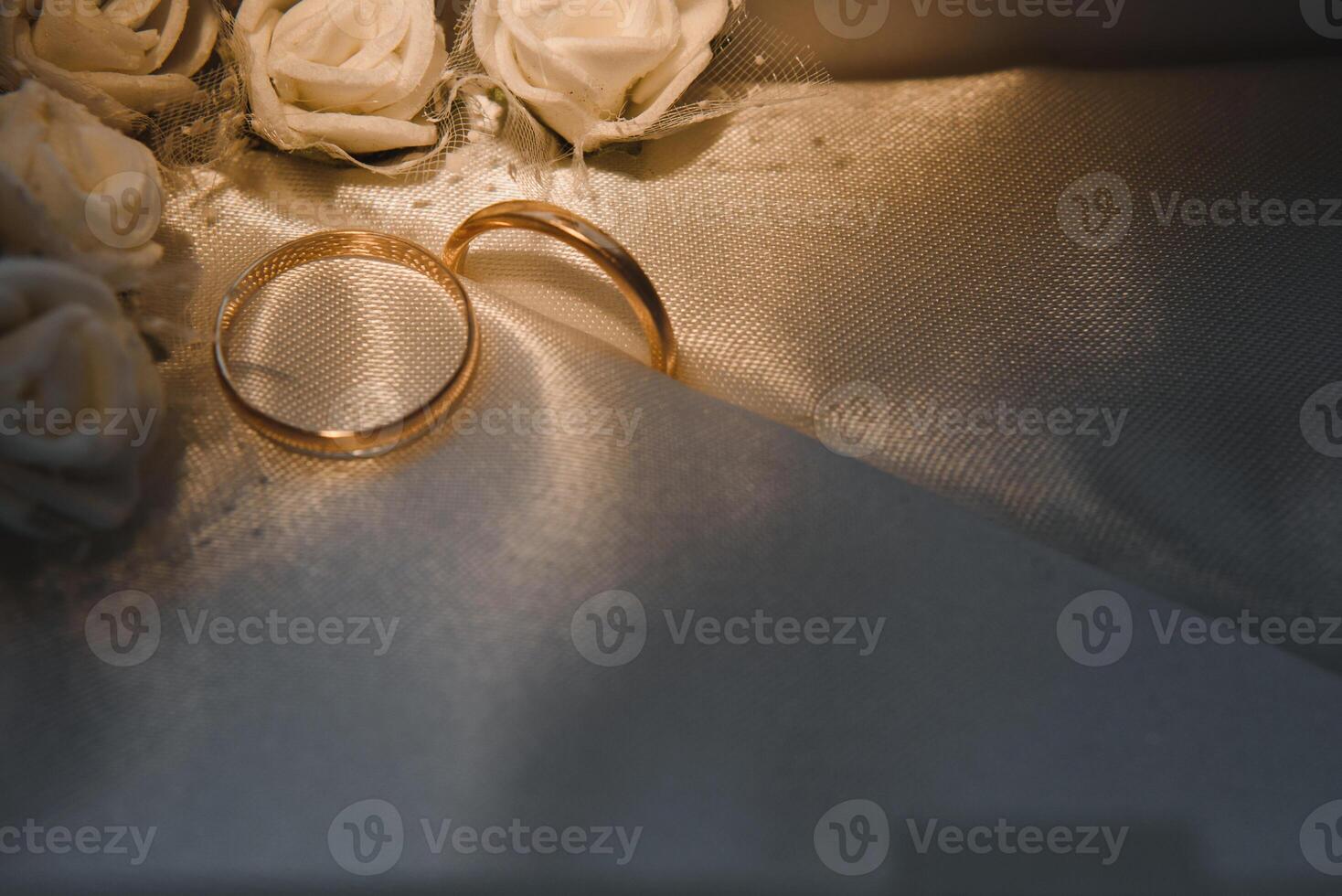 Beautiful wedding gold rings on dark background photo