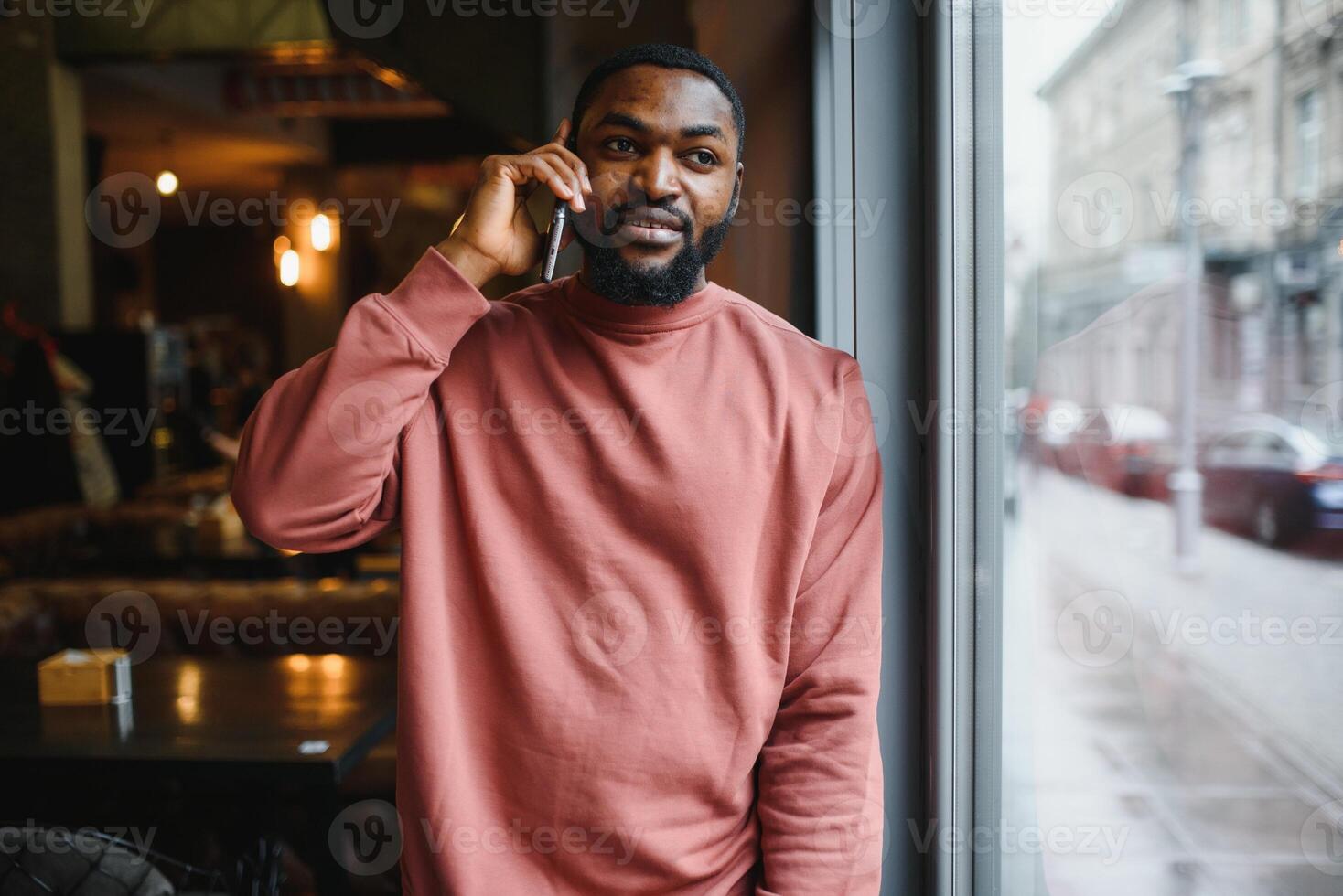 mature african american man talking by phone in cafe. photo