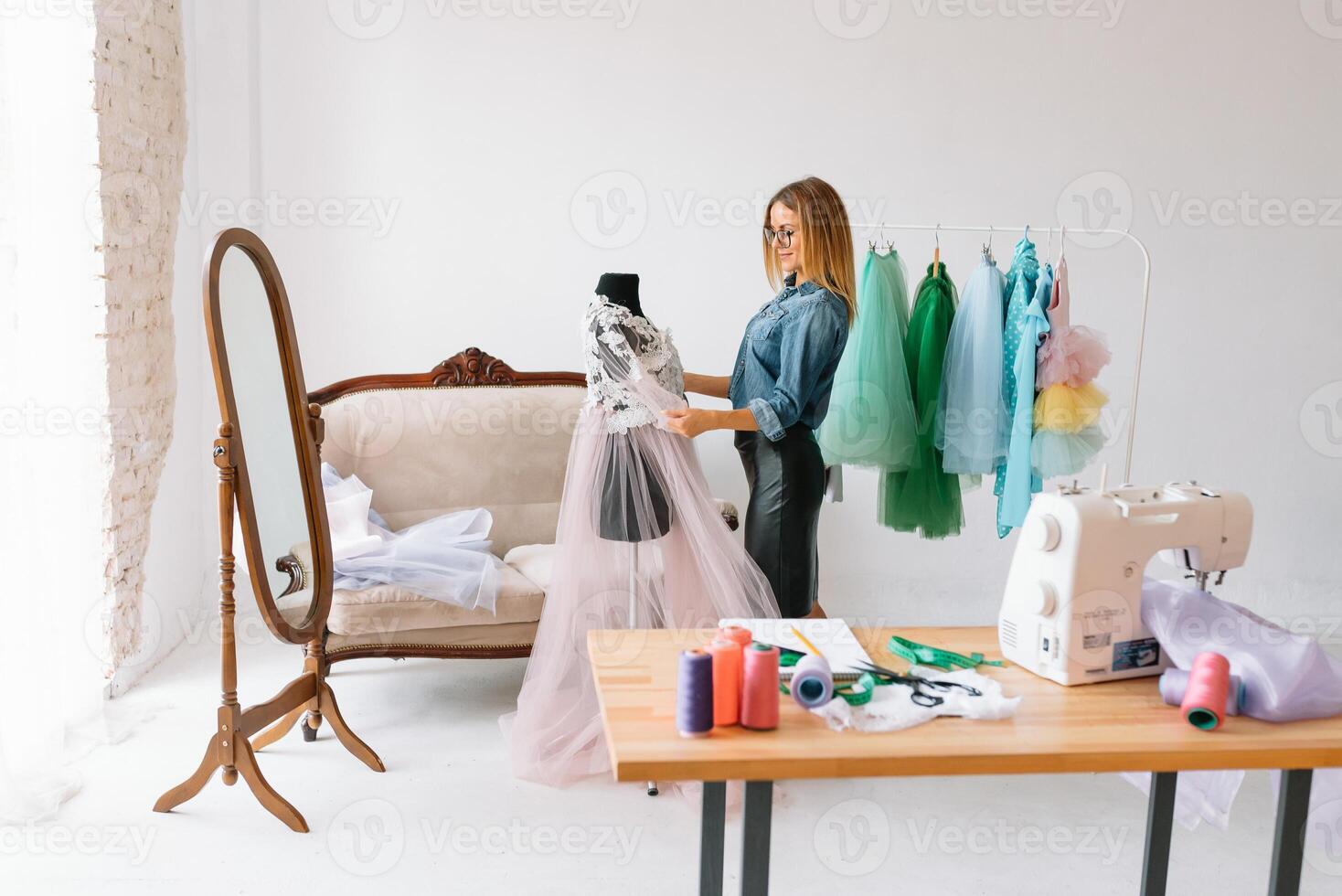 Can't make any mistake. Female fashion designer works on the new clothes in the workshop. photo