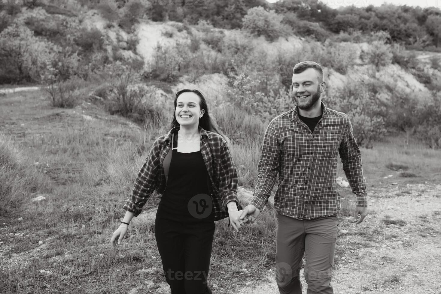 Couple in love rest on green hill in country side photo