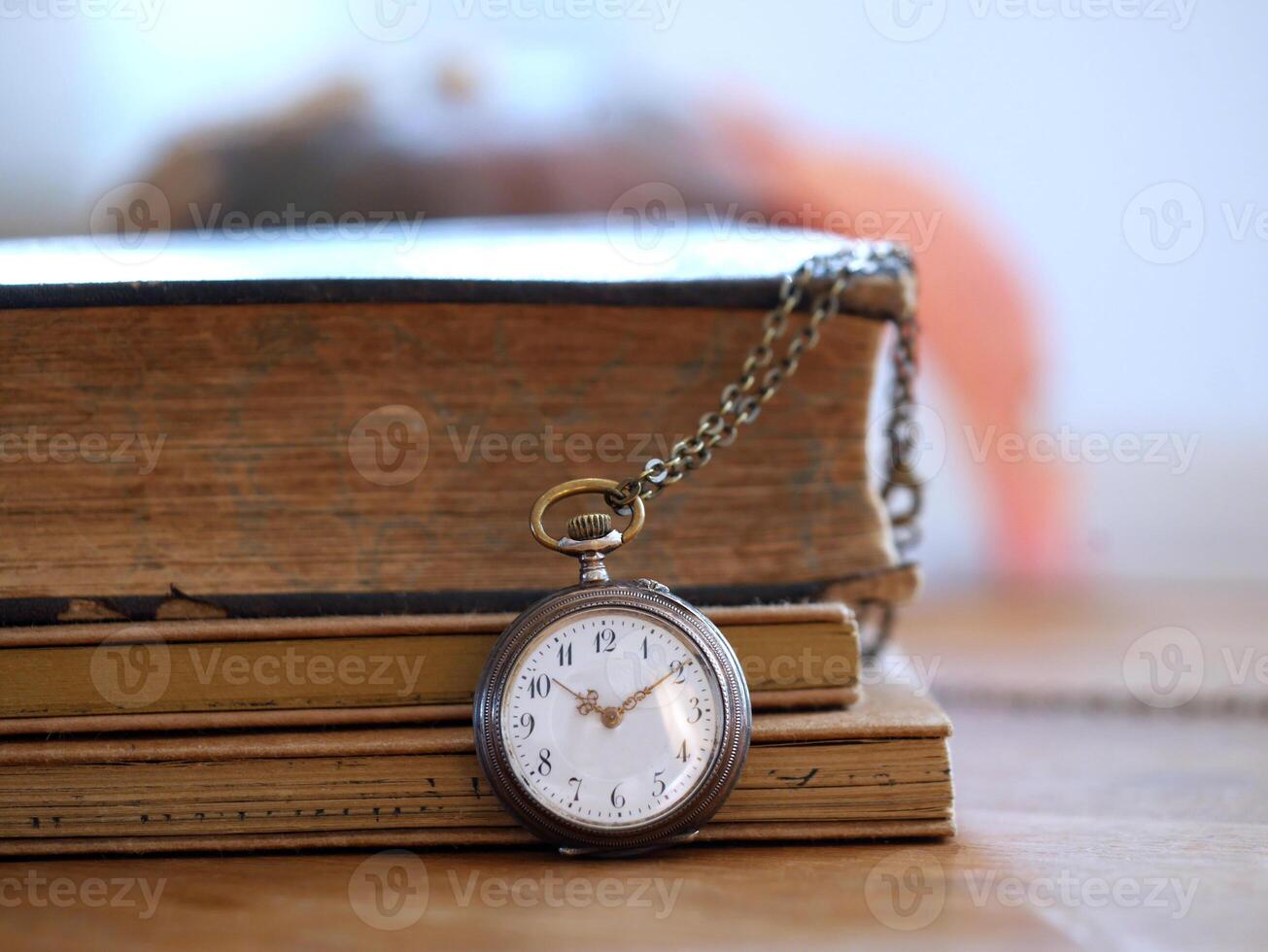 old watch in front of a book photo