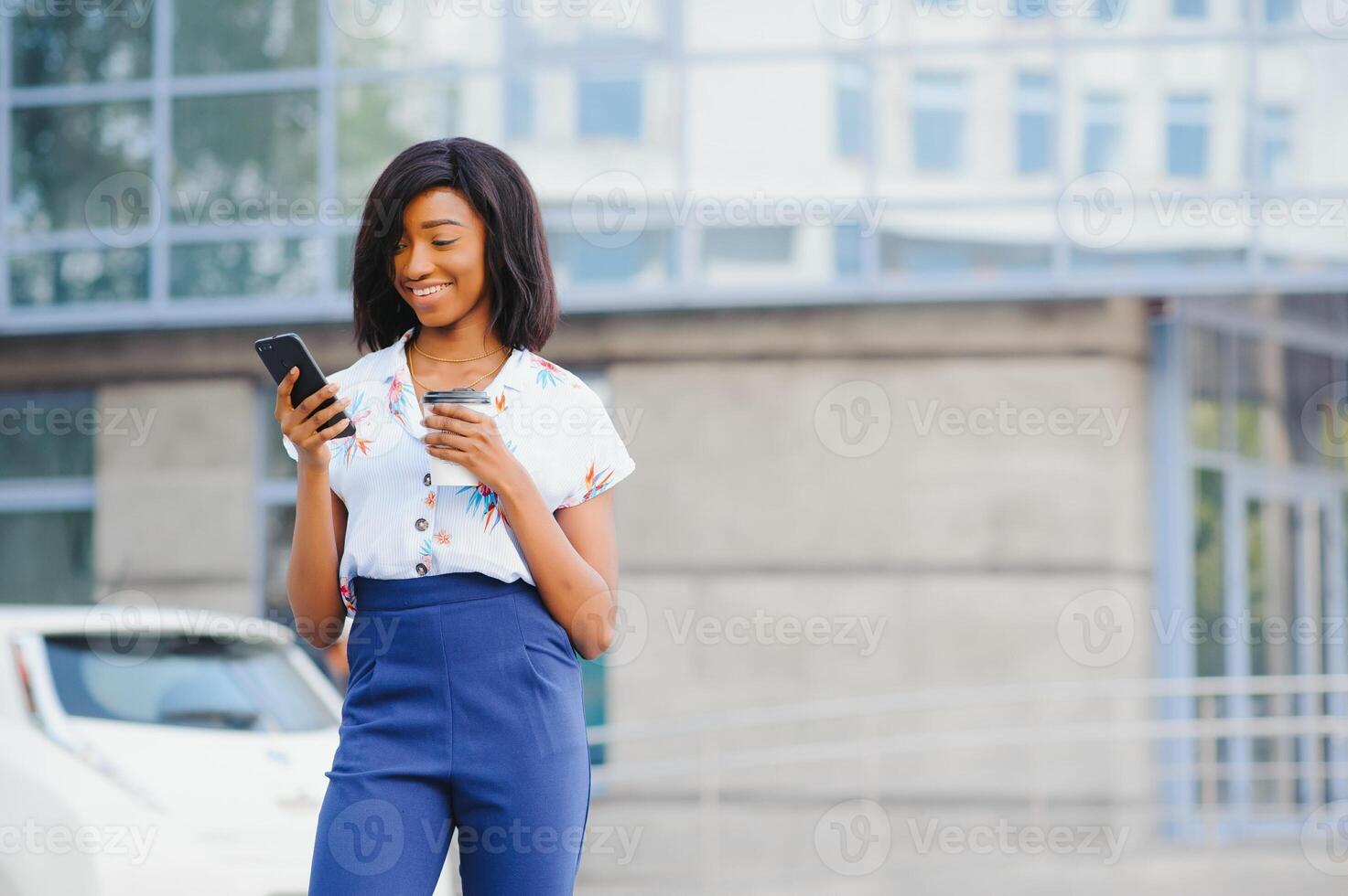 A pretty African american business woman talking on a cell phone at office building photo