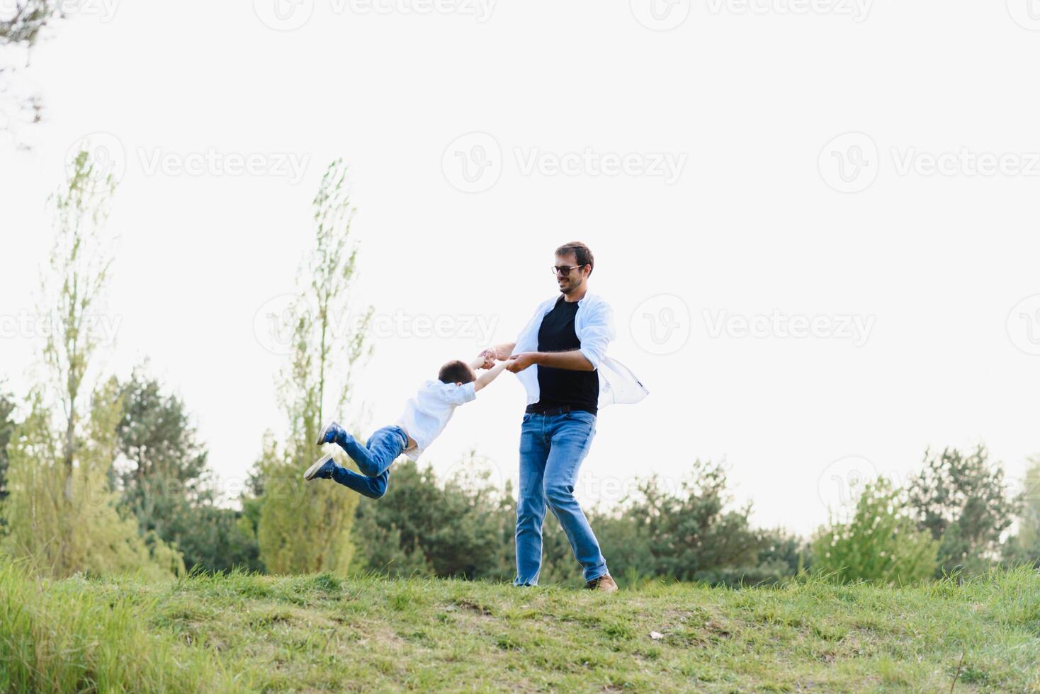 father and son have fun together in nature. Father and son playing. People having fun outdoors. Concept of friendly family. photo