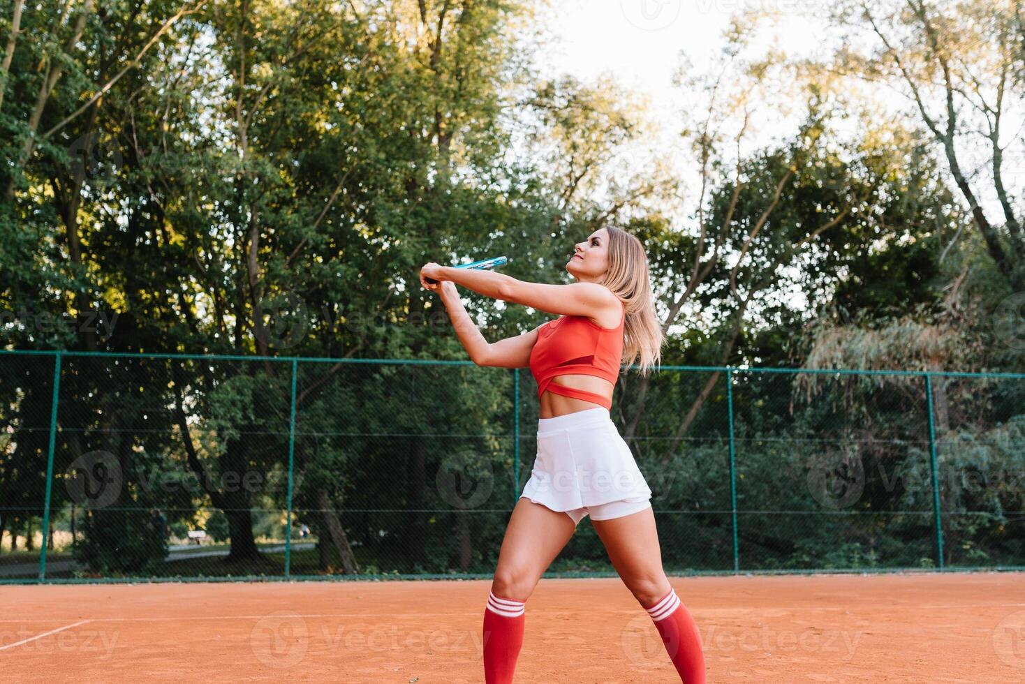 Woman in sportswear plays tennis at competition photo