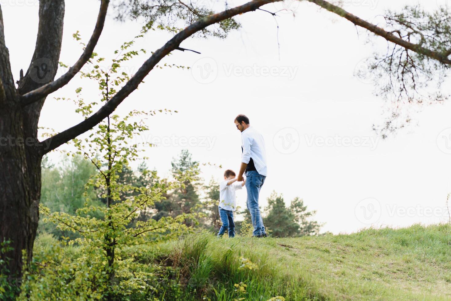 father and son have fun together in nature. Father and son playing. People having fun outdoors. Concept of friendly family. photo