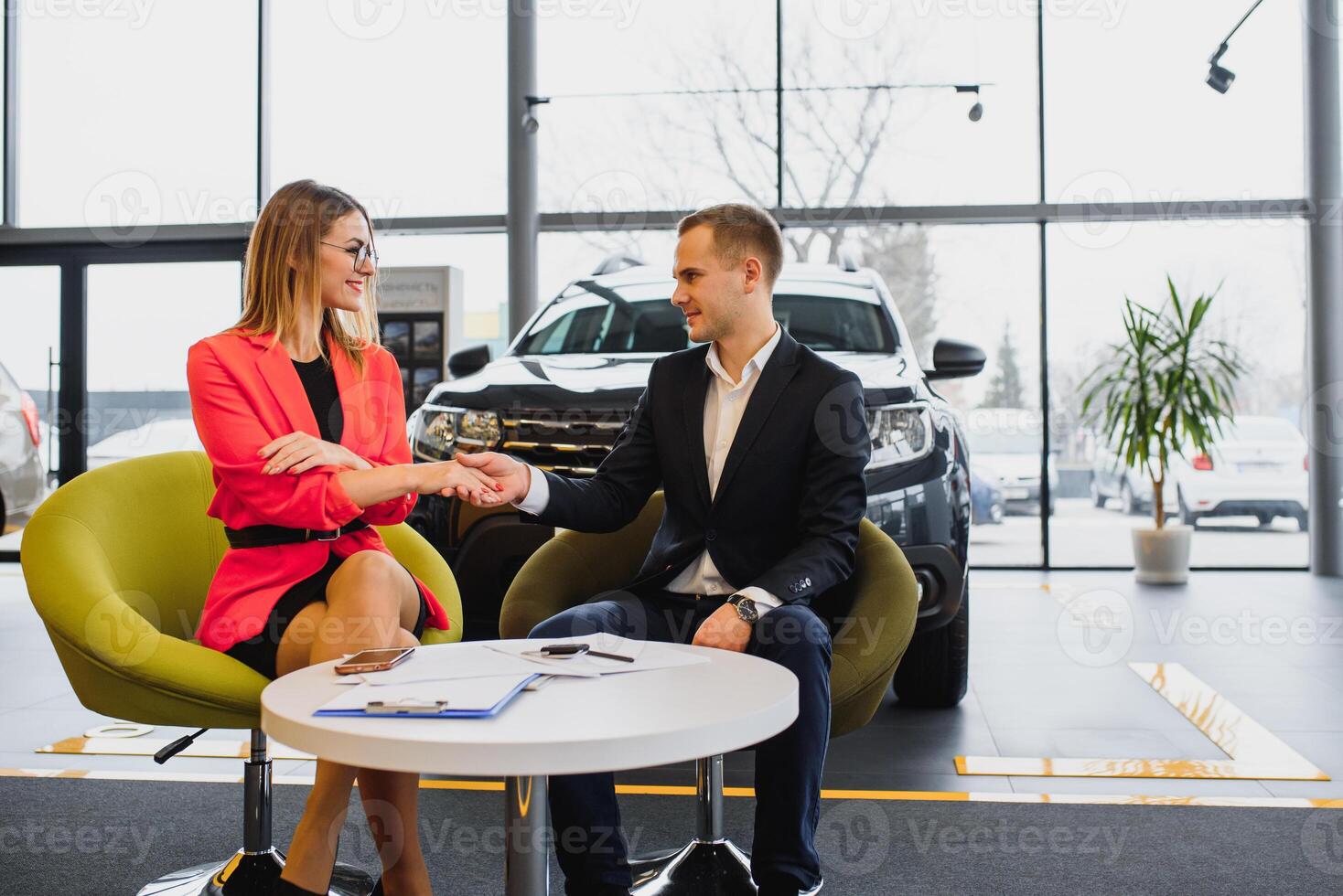 business woman buys a car at a car dealership. Concept of happy business people photo