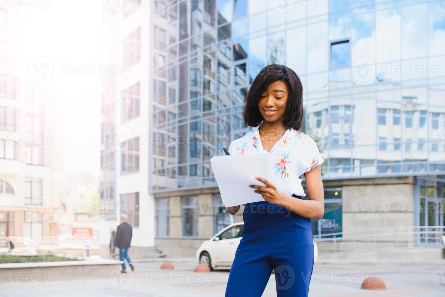 business black woman holding a cup of coffee and files photo