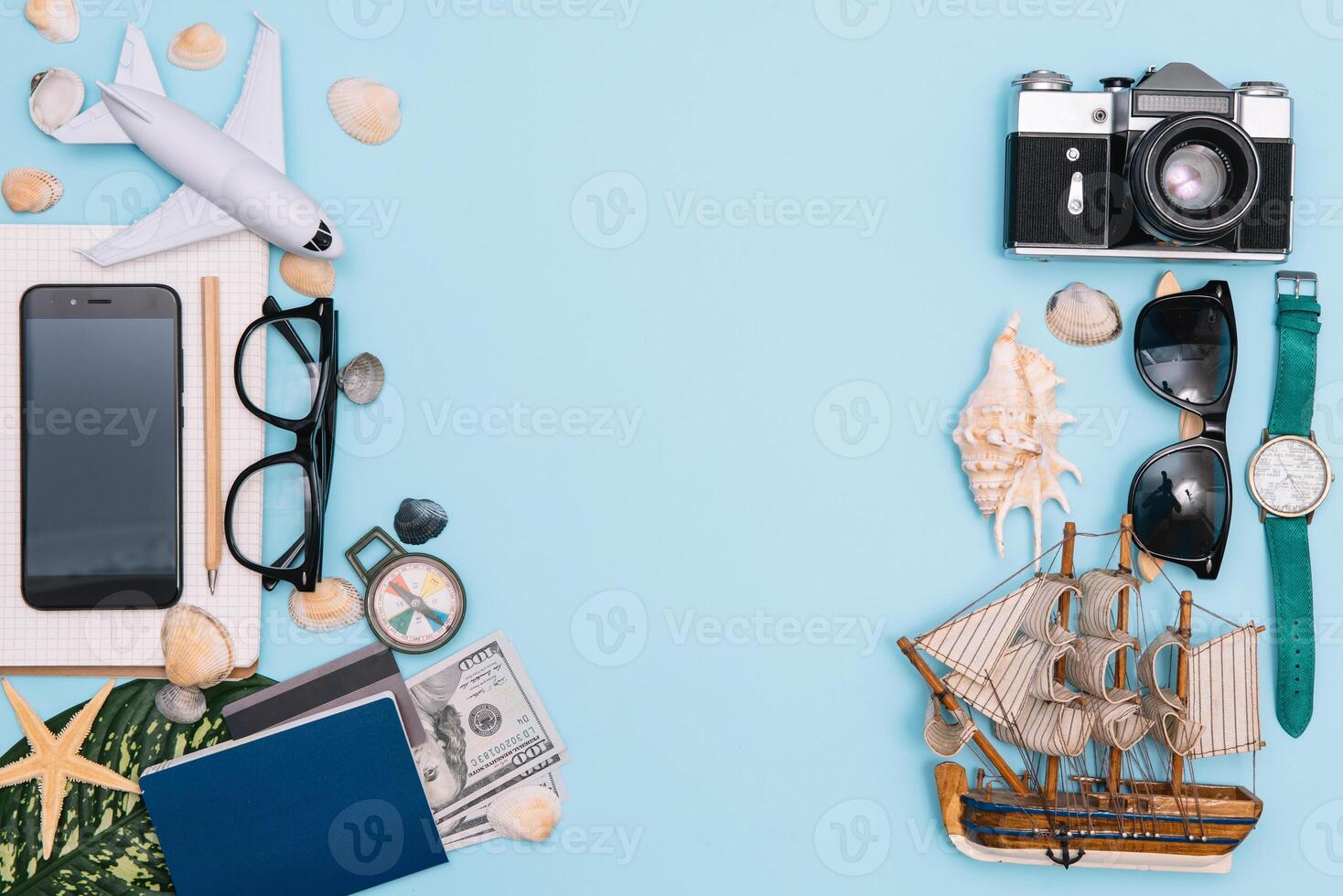 top view travel concept with retro camera films, smartphone, map, passport, compass and Outfit of traveler on blue background with copy space, Tourist essentials, vintage tone effect photo