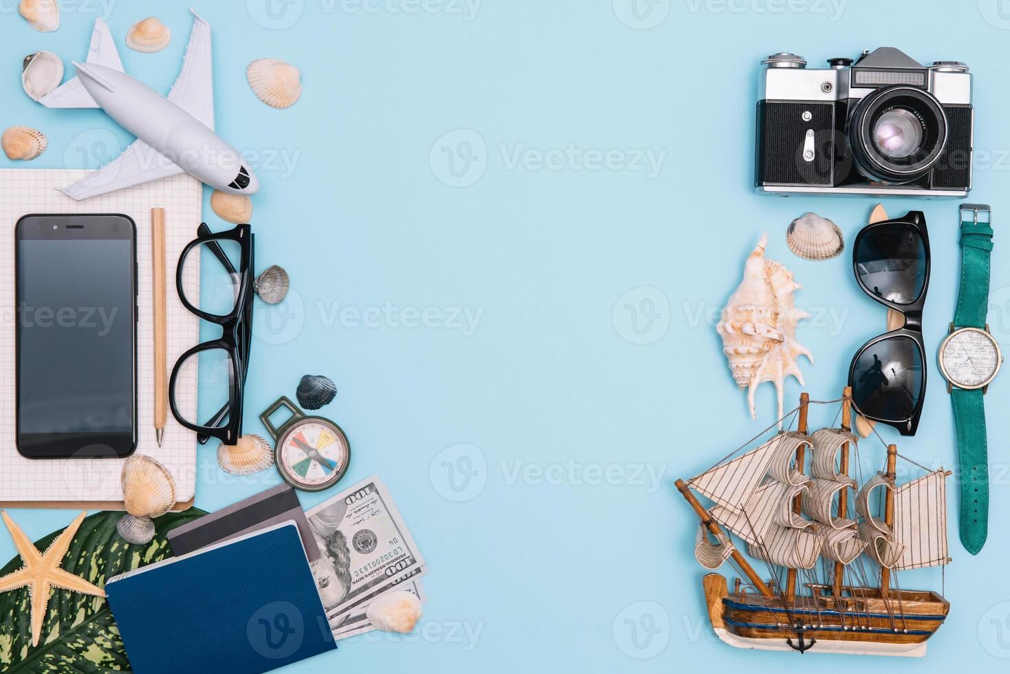 top view travel concept with retro camera films, smartphone, map, passport, compass and Outfit of traveler on blue background with copy space, Tourist essentials, vintage tone effect photo