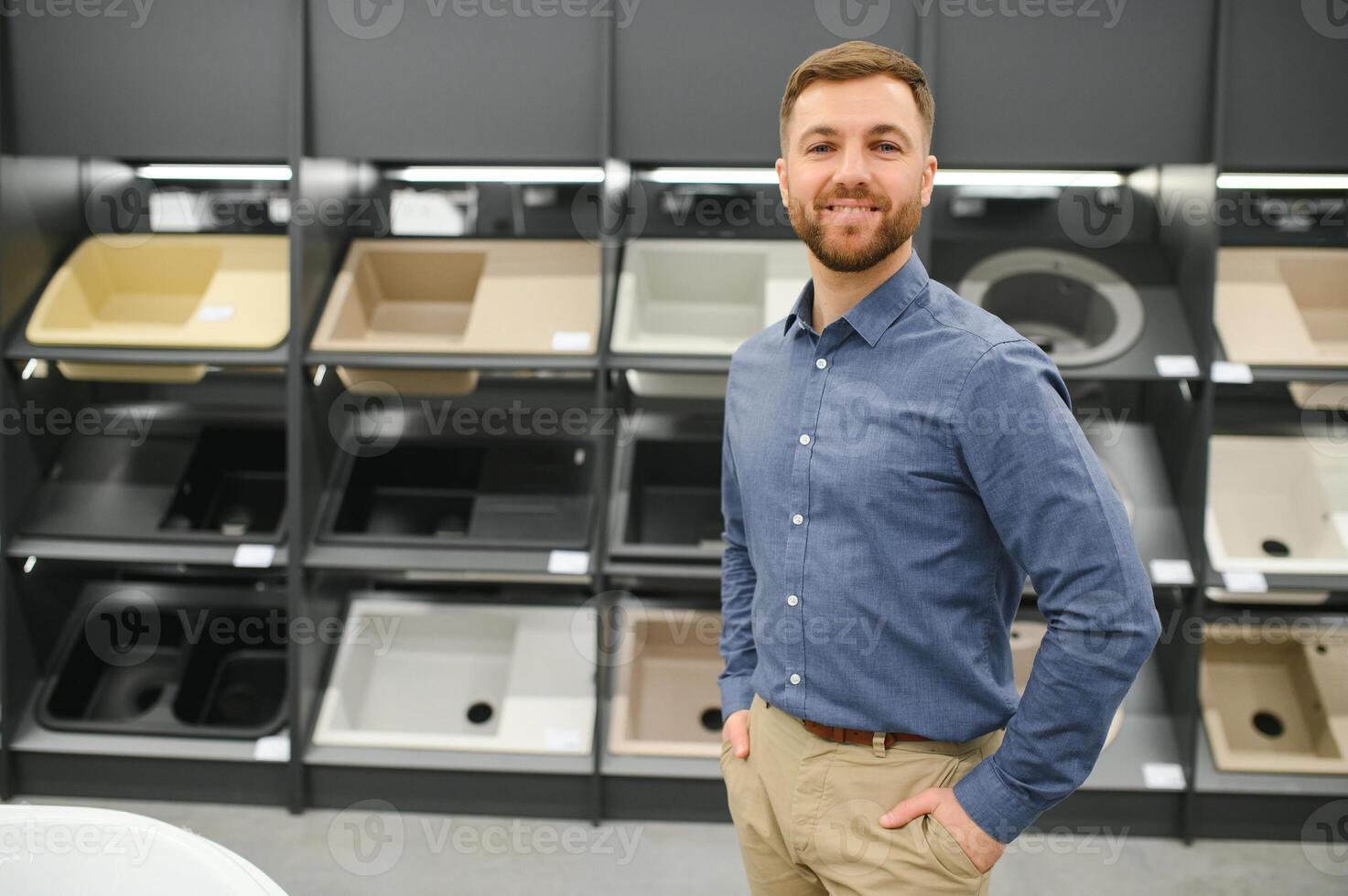 Stylish beautiul man is in the store of goods for the home photo