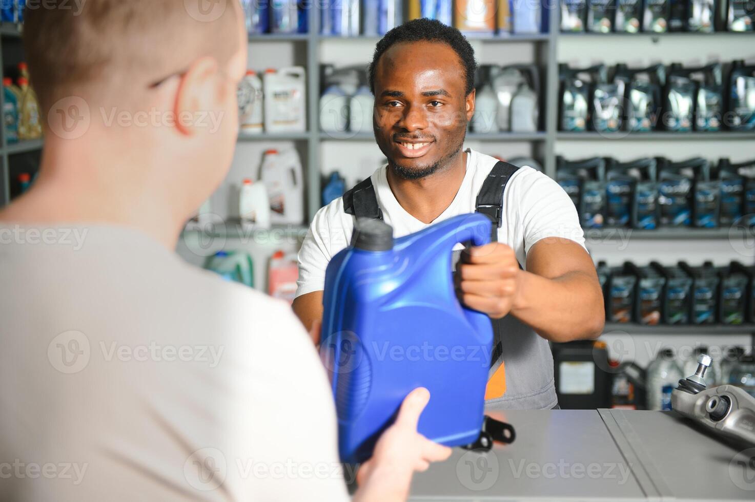 A customer is talking to a salesperson at an auto parts store photo