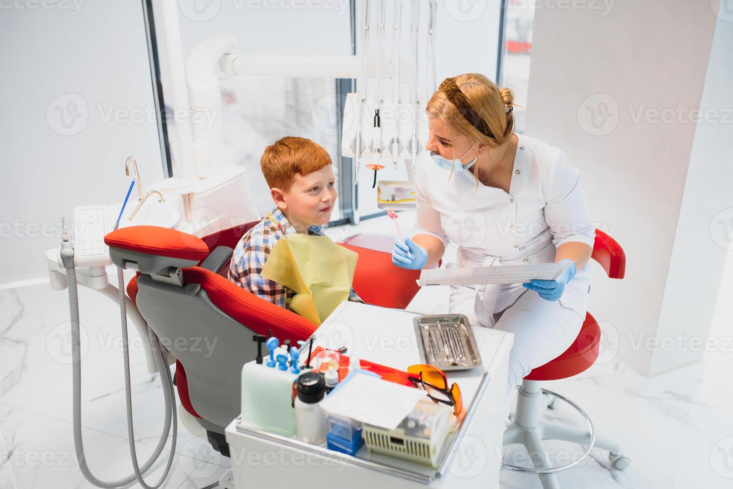 Boy satisfied with the service in the dental office. concept of pediatric dental treatment photo