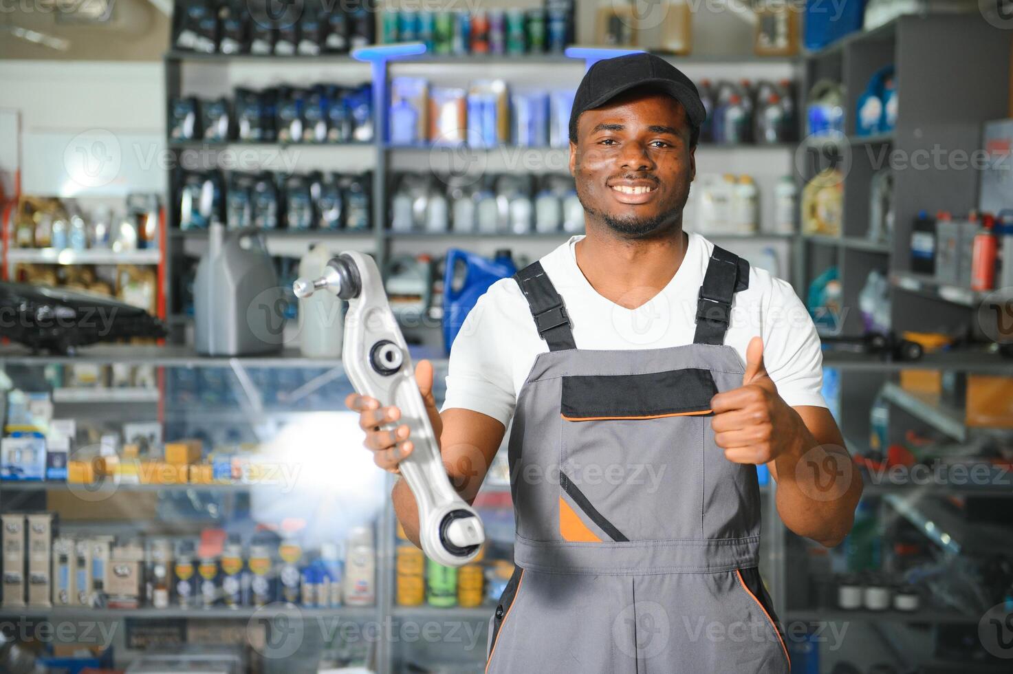 Portrait of a handsome african salesman in an auto parts store. The concept of car repair photo