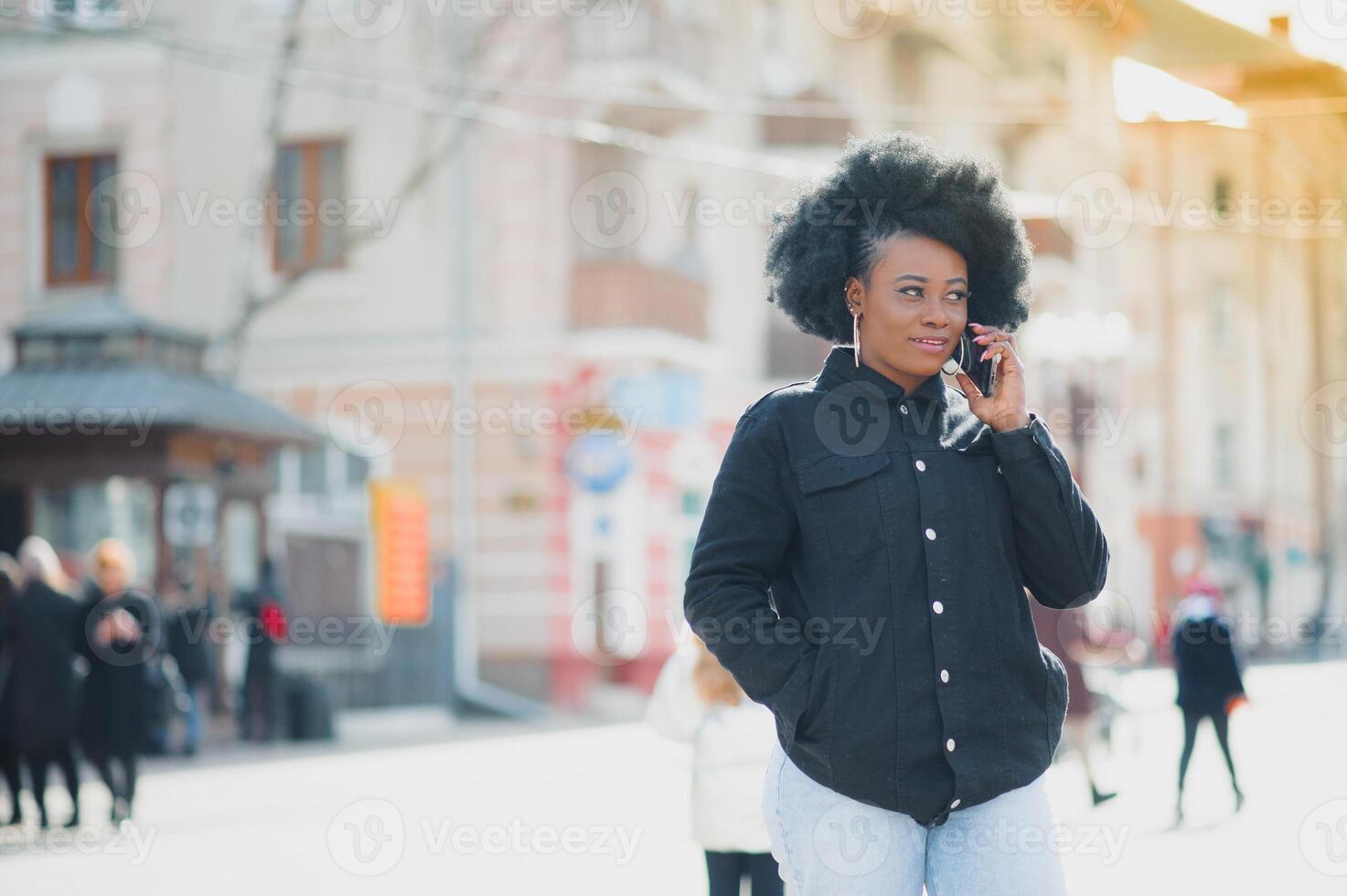 Outdoor close up portrait of young cute happy smiling african american woman with afro hairstyle. photo