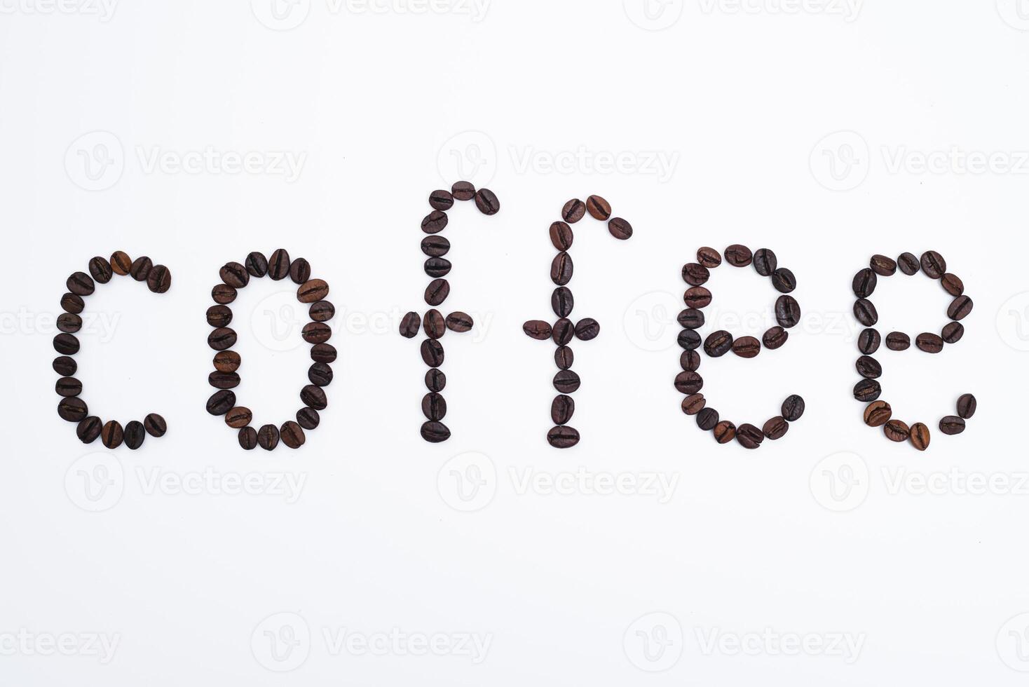 Word coffee made from coffee beans isolated on white background photo