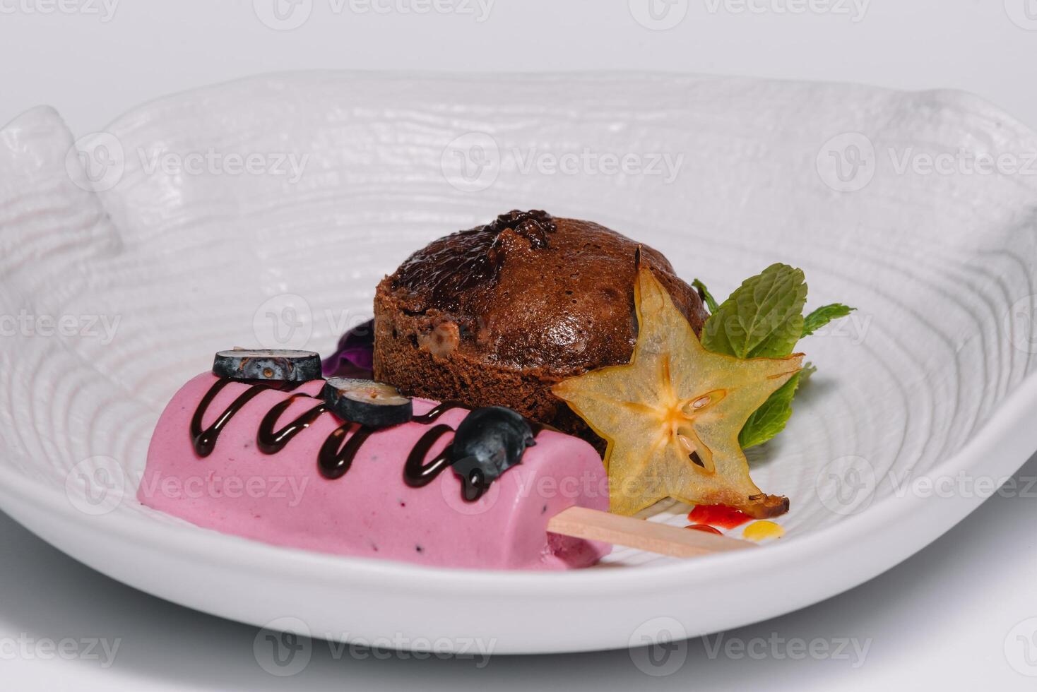 Chocolate fondant with vanilla ice cream and raspberry sauce photo