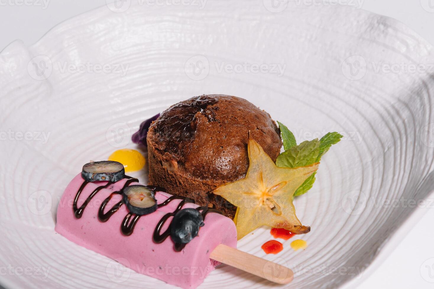 Chocolate fondant with vanilla ice cream and raspberry sauce photo