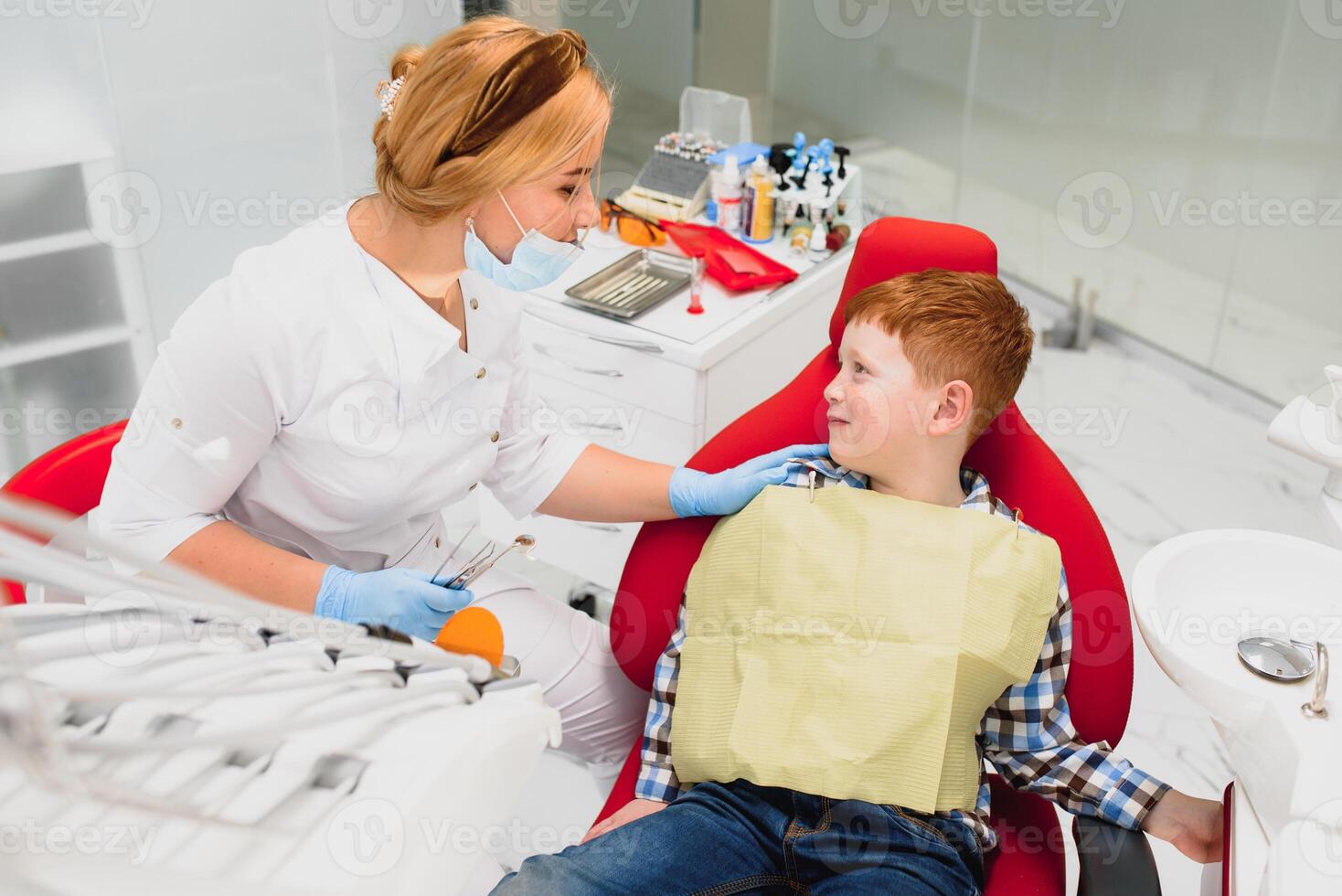 Female dentist and child in a dentist office photo