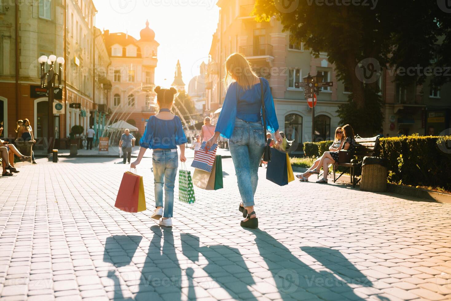 sale, consumerism, money and people concept - happy young woman with shopping bags and credit card in mall photo