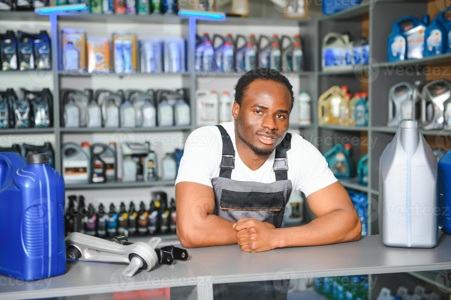 Portrait of a handsome salesman in an auto parts store. The concept of car repair photo